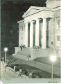 People sitting around the terrace and portico of Old Capitol at night, The University of Iowa, 1927