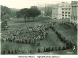 Commencement procession on Pentacrest with crowd looking on, The University of Iowa, 1945