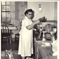Mildred Hahlen cooking in White house kitchen with corgy at her feet
