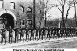 Cadets aiming rifles south of Old Armory, The University of Iowa, 1919