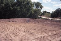 Bulldozed earth near gravel road
