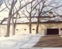 Front of barn with garage door open in winter