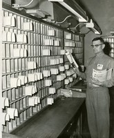 Herman L. (Chet) Walker working in post office
