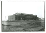 Man working on the front (north) side first floor window of State Gymnasium