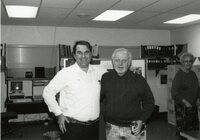 1992 - Two smiling men stand in office