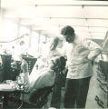 Dental instructor with student examining patient, The University of Iowa, 1940s