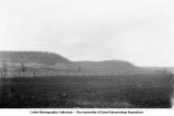 The effects of geologic structure on topographic form within the driftless area. The gently undulating, lower slopes are underlain by Maquoketa Shale, the steep hills in the background are of the overlying Niagaran Limestone. Graf, Iowa, late 1890s or early 1900s