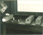 Child fitting pegs in holes, The University of Iowa, 1920s
