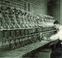 Man working with distillery equipment, The University of Iowa, 1930s