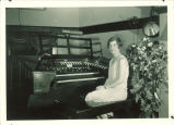 Woman seated at organ, The University of Iowa, 1920s