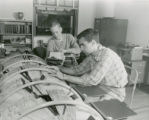 Ray Follette and Dick Sperring checking alumni files, Homecoming, 1951