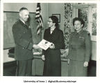 Jean Homewood of the US Army Europe Special Services Athletic Program receiving a certificate, The University of Iowa, November 13, 1957