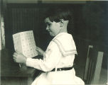 Girl viewing pictures, The University of Iowa, ca. 1920