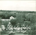View of a parking lot and greenhouse from upper floor of a campus building, The University of Iowa, May 1952