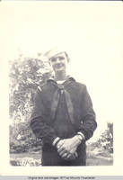 Ray Heitzman in uniform standing in rock garden