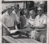 Flossie and Eugene Coltrane inspecting their farm's Conservation Plan for the Register and Tribune Contest.