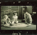 Woman teaching children about trains using a poster and a toy engine, The University of Iowa, January 12, 1938