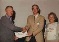 Unidentified man receiving award at Conservation Award Banquet in 1992