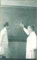 Teacher drawing diagram for dental student, The University of Iowa, 1940s
