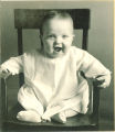 Laughing baby in a chair, The University of Iowa, 1920s