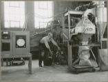 Researcher with the quick curing fertilizer dryer, 1953 or 1954