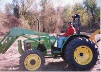 2002  Terrance Rudolph, Des Moines County Soil and Water Conservation District Conservationist, drives a  John Deere tractor.