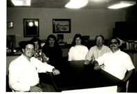 Six People Sitting Around Office Table