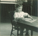 Toddler playing with a puzzle, The University of Iowa, 1920s
