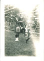 Girl dancing to music of Scottish Highlanders bagpiper, The University of Iowa, 1938
