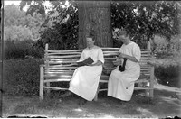 UP479 Ellen Hanson mend and a woman reading on bench