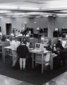 Students using computer stations near the circulation desk