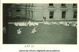 Women in costume dancing on the Pentacrest lawn, The University of Iowa, June 1924