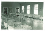 Nurse holding baby in Children's Hospital pediatric ward, The University of Iowa, 1926