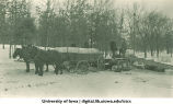 Men unloading a horse-drawn wagon carrying ice, The University of Iowa, 1920s