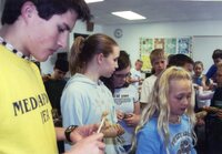 Students make pine cone bird feeders