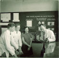 Instructor shows some dental students a model of teeth, The University of Iowa, 1940s
