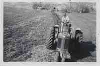 Man on Tractor Plowing Field