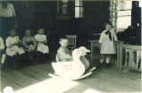 Children in play room with rocker toy, The University of Iowa, ca. 1920