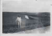 Steve Hemmelman stands by fence in field in Plymouth County, Iowa