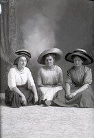 Three women sitting on floor