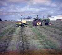 Man on Tractor Pulling Trailer with Chemicals