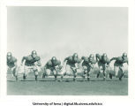 Football players running, The University of Iowa, June 1947