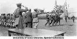 Colors carried past VIPs during Governor's Day ceremony on Iowa Field, The University of Iowa, May 19, 1928
