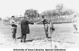 Governor N.E. Kendall presenting award to cadet on Iowa Field, The University of Iowa, June 4, 1921