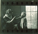 Woman looks in a small girl's mouth using a flashlight, The University of Iowa, May 10, 1941
