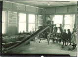 Small children playing on an indoor slide, The University of Iowa, 1920s