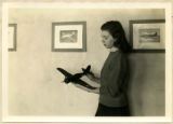 A cadette is holding one of the completed model airplanes,  1943