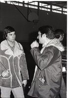 Howard Bright and another man talk in gym