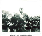 Iowa football players carrying coach Forest Evashevski, The University of Iowa, 1952