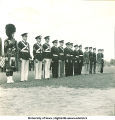 Soldiers and man in kilt stand in formation, The University of Iowa, 1950s